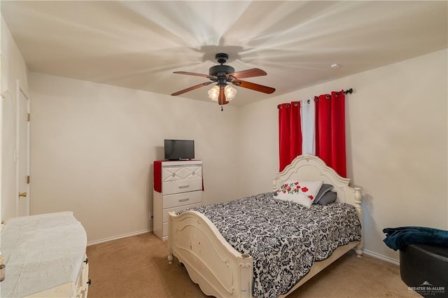 bedroom with baseboards, a ceiling fan, and light colored carpet