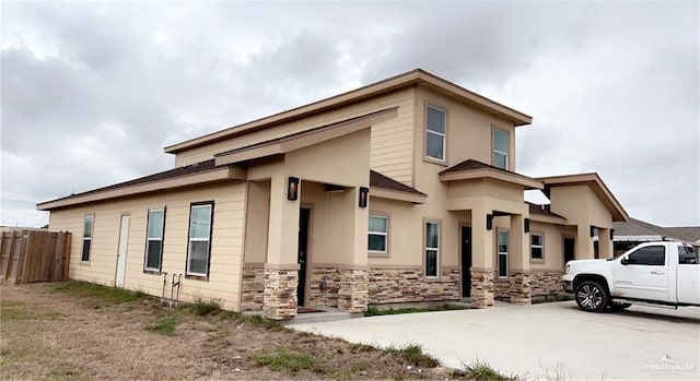 view of home's exterior with driveway and fence