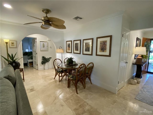 dining area featuring crown molding and ceiling fan