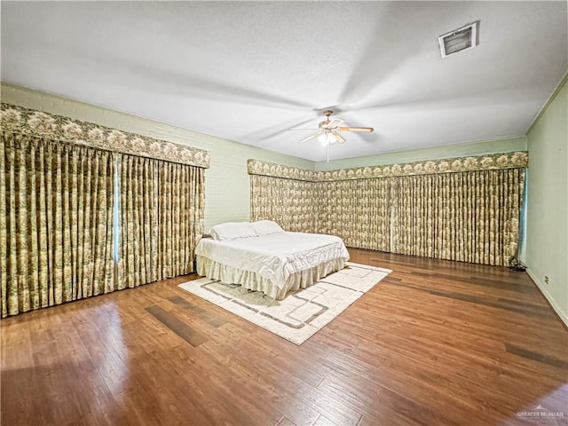 bedroom with hardwood / wood-style floors and ceiling fan