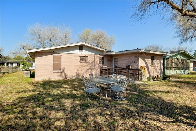 rear view of property featuring a yard