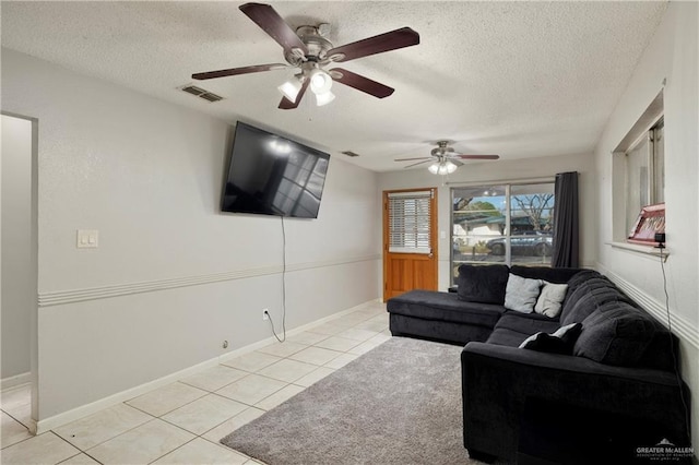 tiled living room featuring a textured ceiling