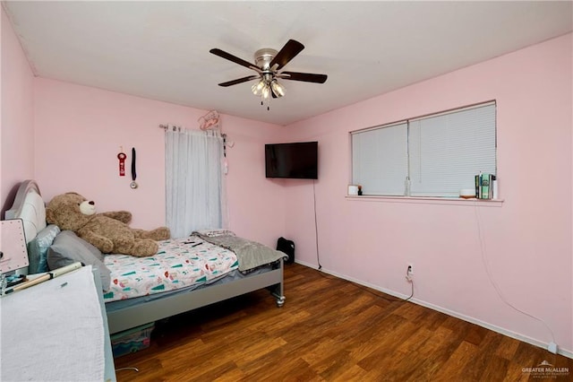 bedroom with dark hardwood / wood-style floors and ceiling fan