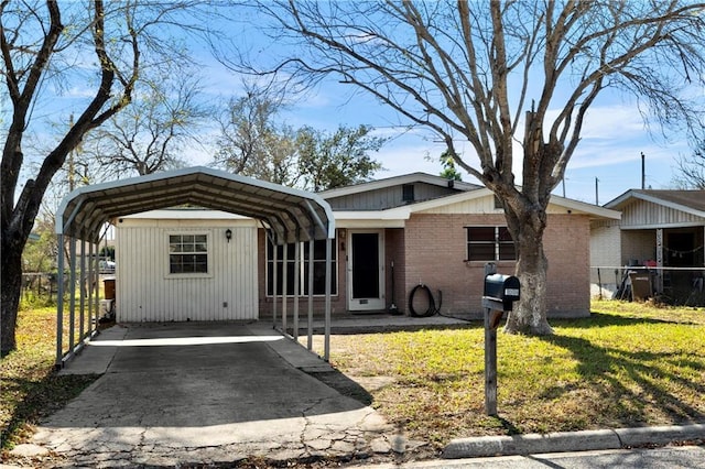 ranch-style home with a carport and a front yard