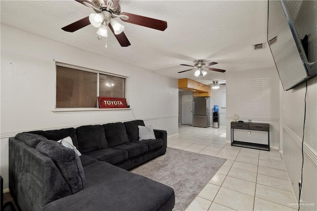 tiled living room with a textured ceiling