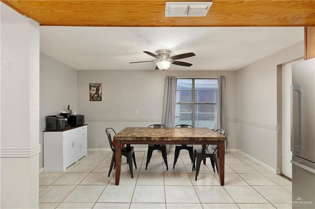 tiled dining space featuring ceiling fan