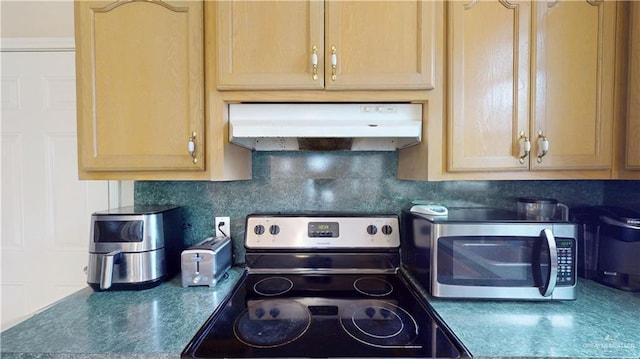 3810 W Sarah Evans St, Edinburg, TX 78541 - kitchen featuring dark countertops, appliances with stainless steel finishes, backsplash, and under cabinet range hood