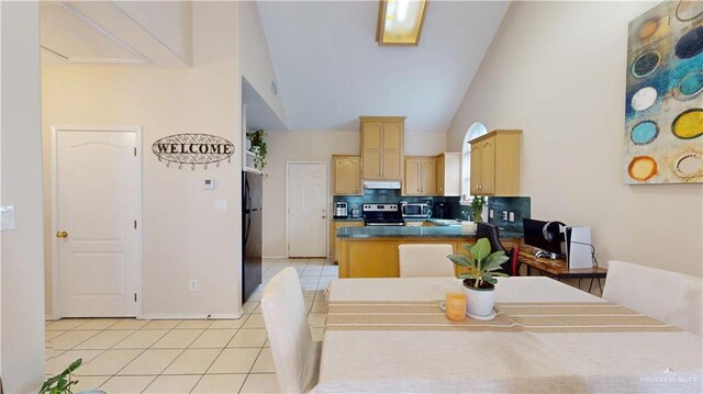 3810 W Sarah Evans St, Edinburg, TX 78541 - kitchen with light tile patterned flooring, light brown cabinets, high vaulted ceiling, under cabinet range hood, and stainless steel appliances