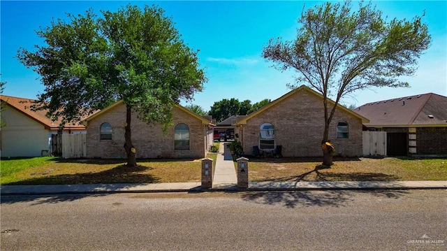 3810 W Sarah Evans St, Edinburg, TX 78541 - view of front of home featuring brick siding, fence, and a front yard