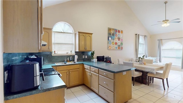 3810 W Sarah Evans St, Edinburg, TX 78541 - kitchen with dark countertops, a sink, high vaulted ceiling, a peninsula, and a ceiling fan