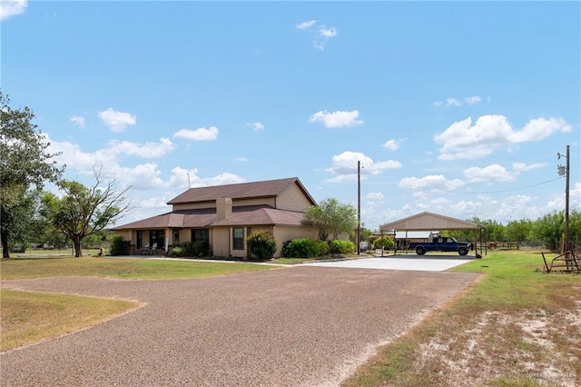 view of front of property featuring a front lawn and a carport