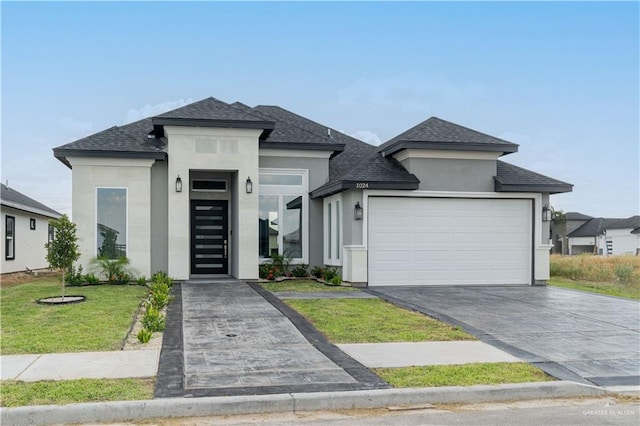 prairie-style house with a garage and a front yard