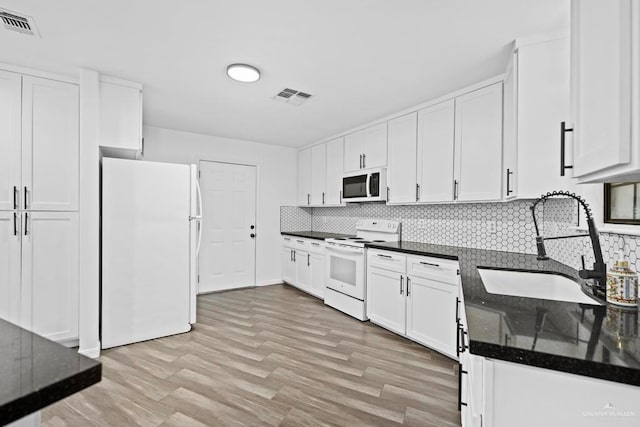 1315 Rio Guadalupe Cir, San Juan, TX 78589 - kitchen with visible vents, white appliances, white cabinetry, and a sink