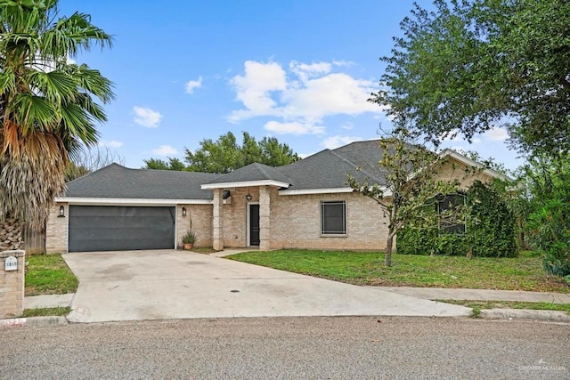 1315 Rio Guadalupe Cir, San Juan, TX 78589 - ranch-style house featuring brick siding, a garage, driveway, roof with shingles, and a front lawn