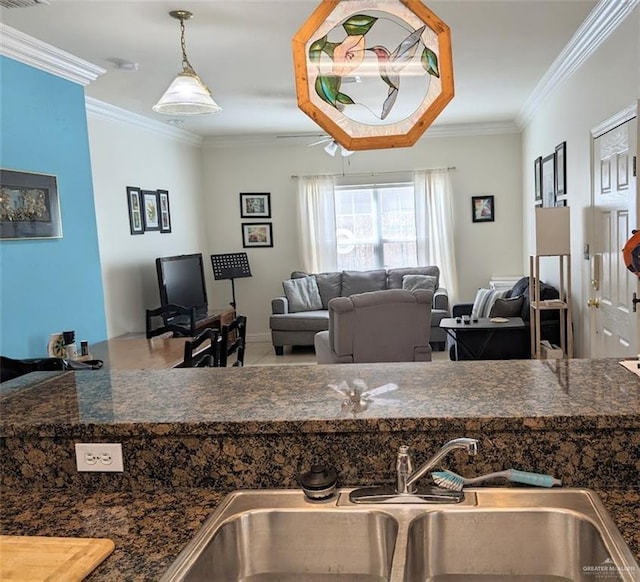109 E Retama St Unit 2, South Padre Island, TX 78597 - kitchen featuring a sink, ornamental molding, dark countertops, and decorative light fixtures