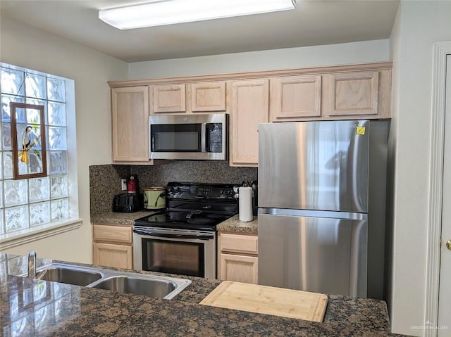 109 E Retama St Unit 2, South Padre Island, TX 78597 - kitchen featuring appliances with stainless steel finishes, light brown cabinets, and healthy amount of natural light