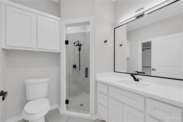 bathroom with walk in shower, vanity, and toilet