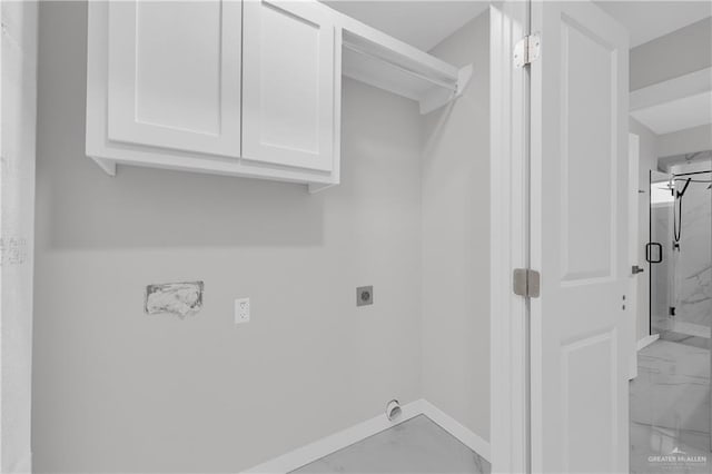 laundry room featuring electric dryer hookup and cabinets