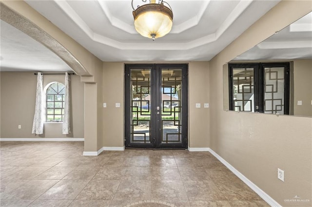 8006 Senecio St, Mission, TX 78574 - foyer featuring french doors, a raised ceiling, arched walkways, and tile patterned floors