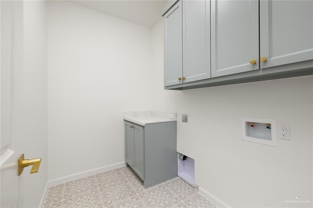 clothes washing area featuring hookup for an electric dryer, cabinets, and washer hookup