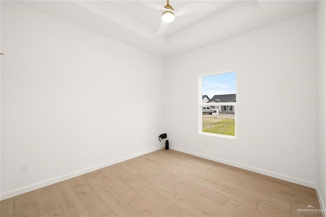 spare room with light wood-type flooring and ceiling fan