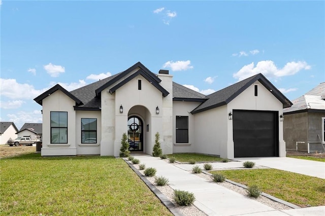 view of front of home with a garage and a front lawn