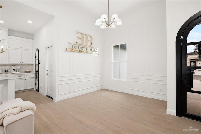 dining space featuring light hardwood / wood-style flooring and an inviting chandelier