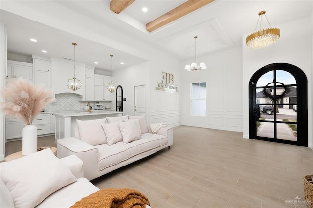 living room with light hardwood / wood-style floors and a high ceiling