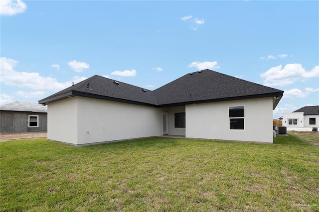 rear view of property with a lawn