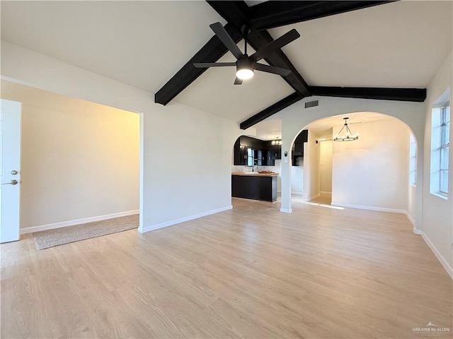 603 Witmer St, Weslaco, TX 78596 - unfurnished living room with arched walkways, ceiling fan, light wood-type flooring, baseboards, and a sink