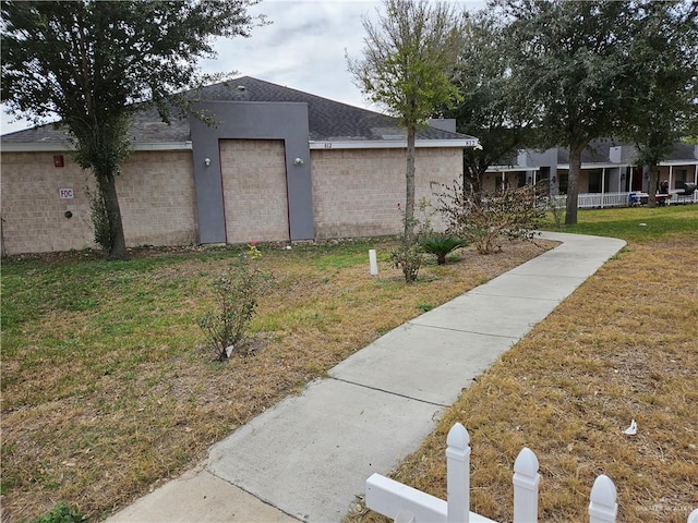 view of side of property with a lawn