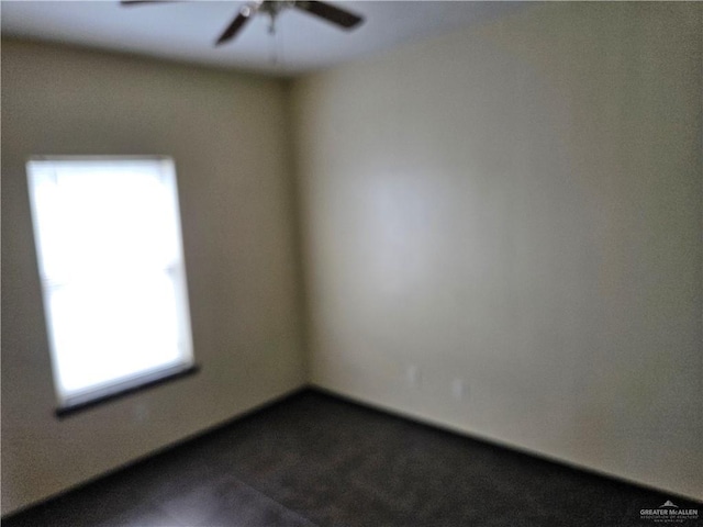 carpeted empty room featuring plenty of natural light and ceiling fan