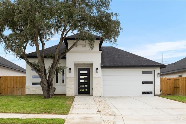 view of front of home with a garage and a front yard