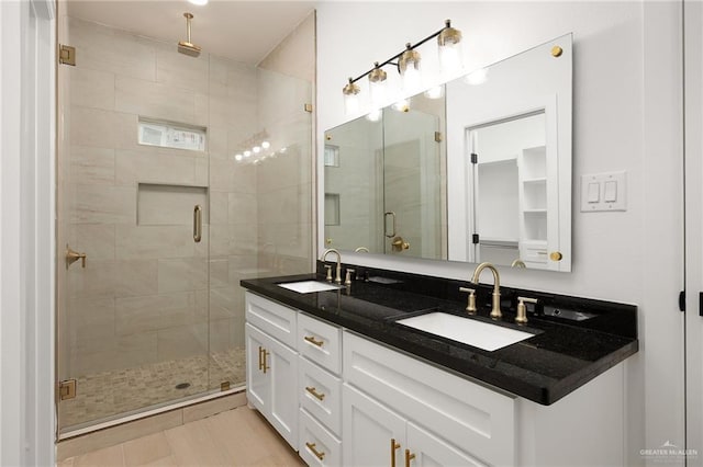 bathroom featuring tile patterned flooring, vanity, and a shower with door