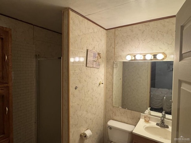 1308 E 2nd St, Weslaco, TX 78596 - full bathroom featuring a shower stall, vanity, toilet, and ornamental molding