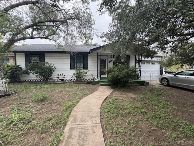 1308 E 2nd St, Weslaco, TX 78596 - ranch-style house featuring a garage and driveway