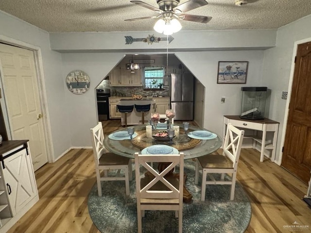 1308 E 2nd St, Weslaco, TX 78596 - dining room featuring light wood-style flooring, ceiling fan, and a textured ceiling
