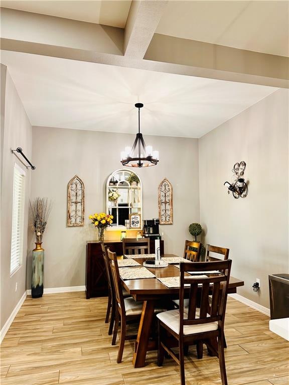 dining room featuring light hardwood / wood-style floors and a chandelier