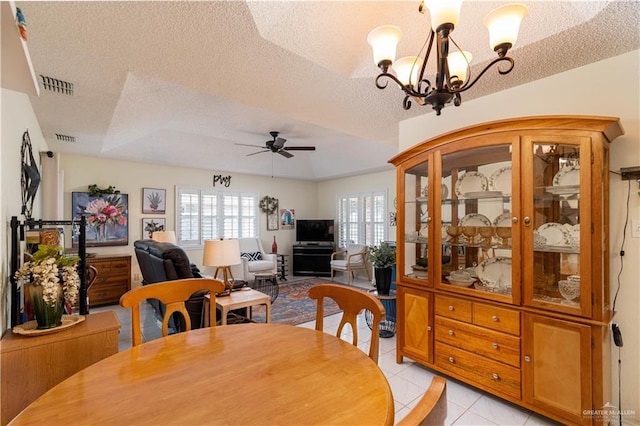 512 Mercury St, Mission, TX 78572 - dining space featuring ceiling fan, a textured ceiling, a chandelier, and light tile patterned floors
