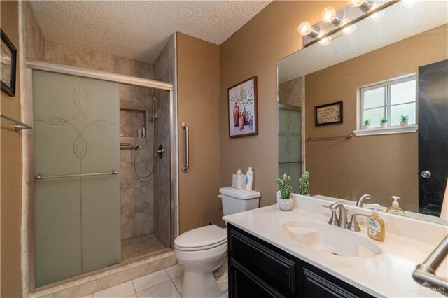 512 Mercury St, Mission, TX 78572 - bathroom featuring toilet, vanity, a shower stall, tile patterned flooring, and a textured ceiling