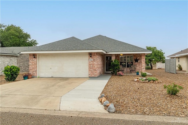 512 Mercury St, Mission, TX 78572 - view of front facade with driveway, an attached garage, brick siding, a shingled roof, and covered porch