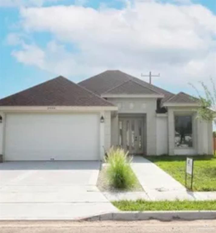 view of front of property featuring a garage and concrete driveway