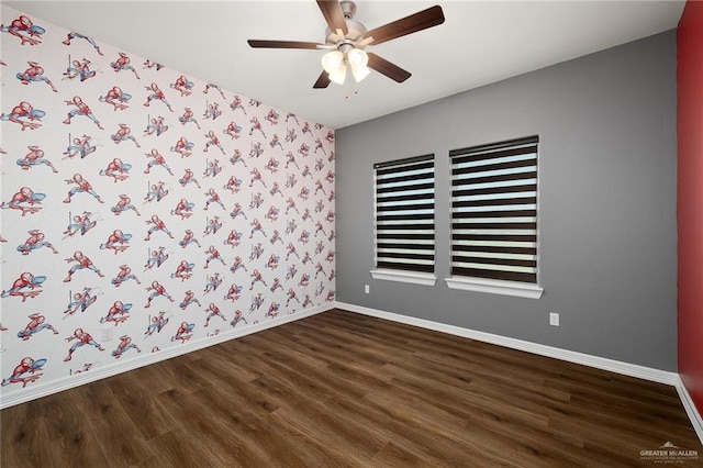 empty room featuring dark hardwood / wood-style flooring and ceiling fan