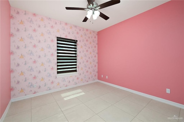 spare room featuring ceiling fan and light tile patterned flooring