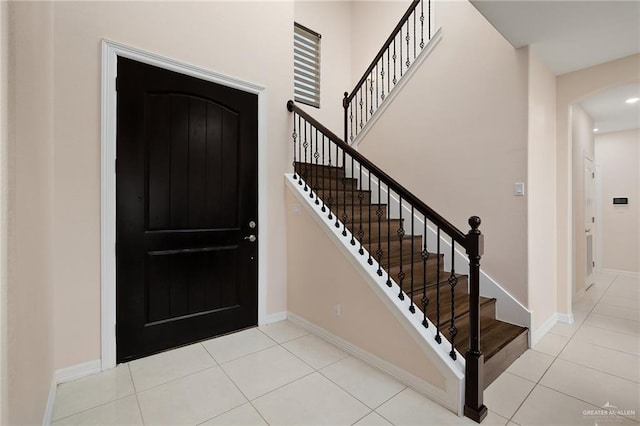 entryway with light tile patterned floors