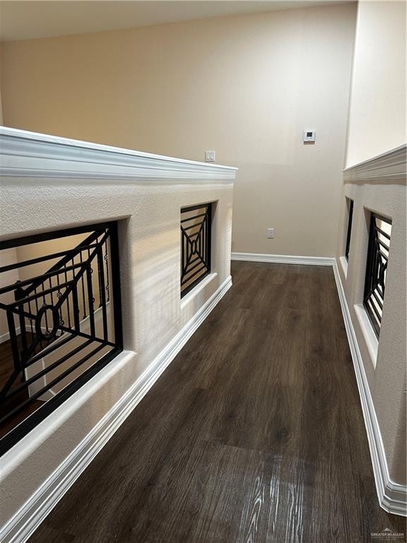 corridor featuring dark hardwood / wood-style floors