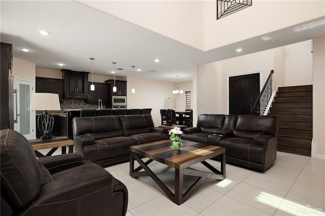 tiled living room featuring a notable chandelier and sink