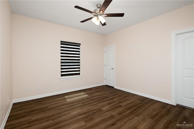 empty room with ceiling fan and dark hardwood / wood-style floors