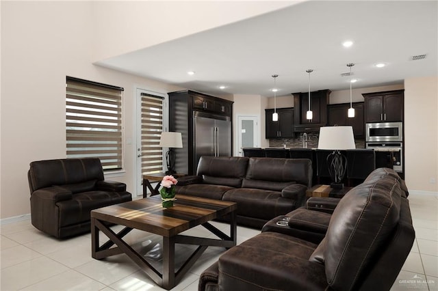 living room with light tile patterned floors and sink