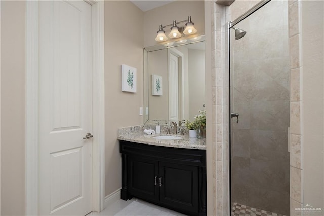 bathroom featuring a shower with door and vanity